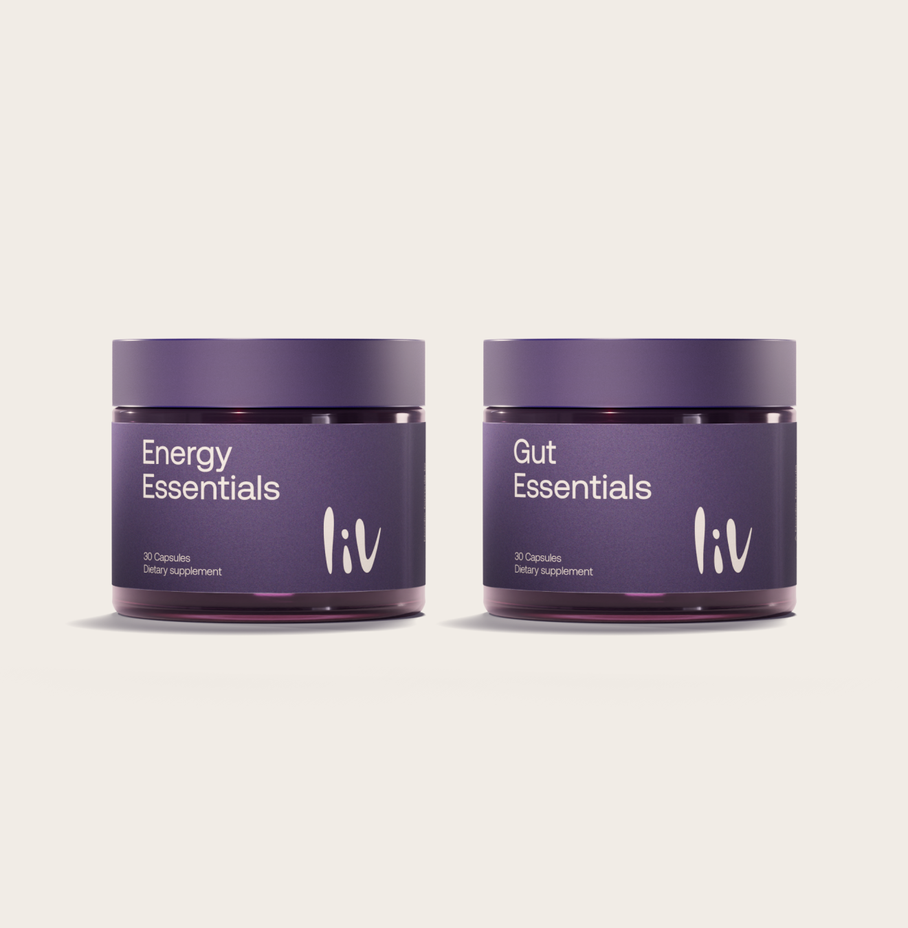 Two purple jars labeled 'Energy Essentials' and 'Gut Essentials' by liv on a light beige background.