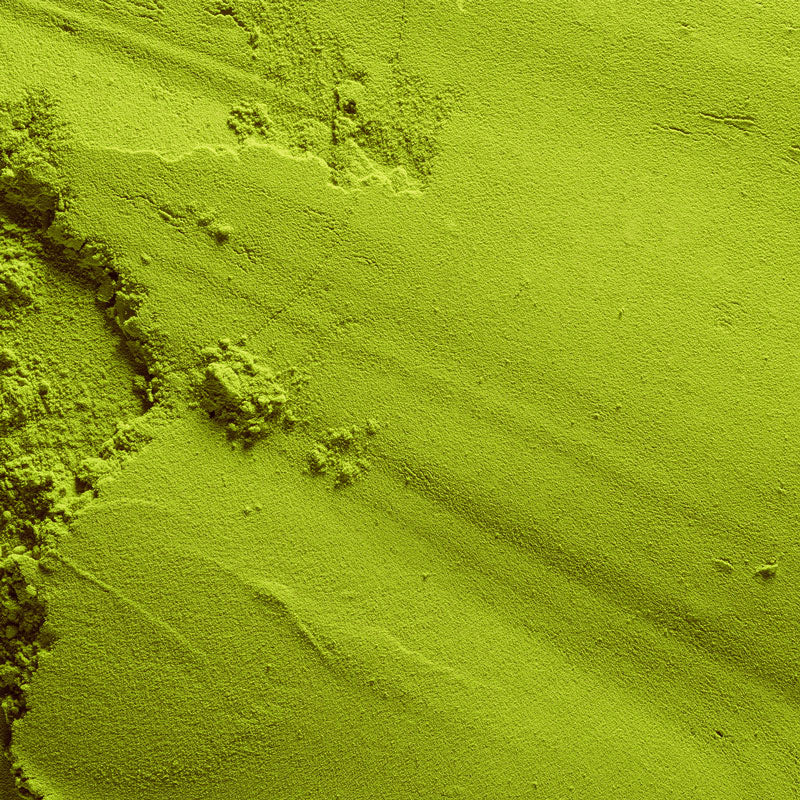 Close-up of green powder with a textured surface