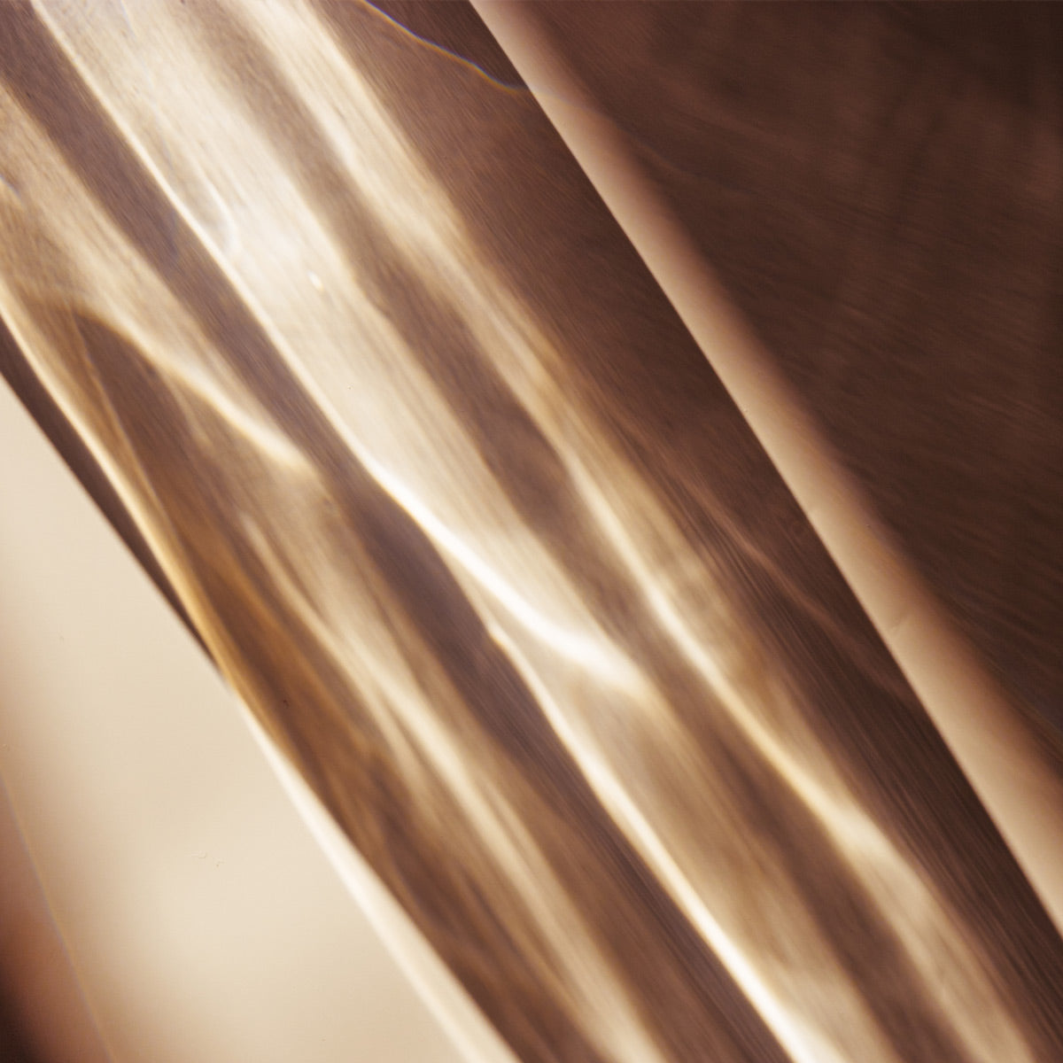 Close-up of smooth, beige fabric with a subtle texture