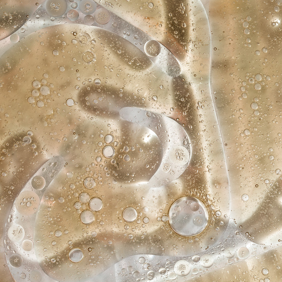 Close-up of oil and water bubbles on a beige background