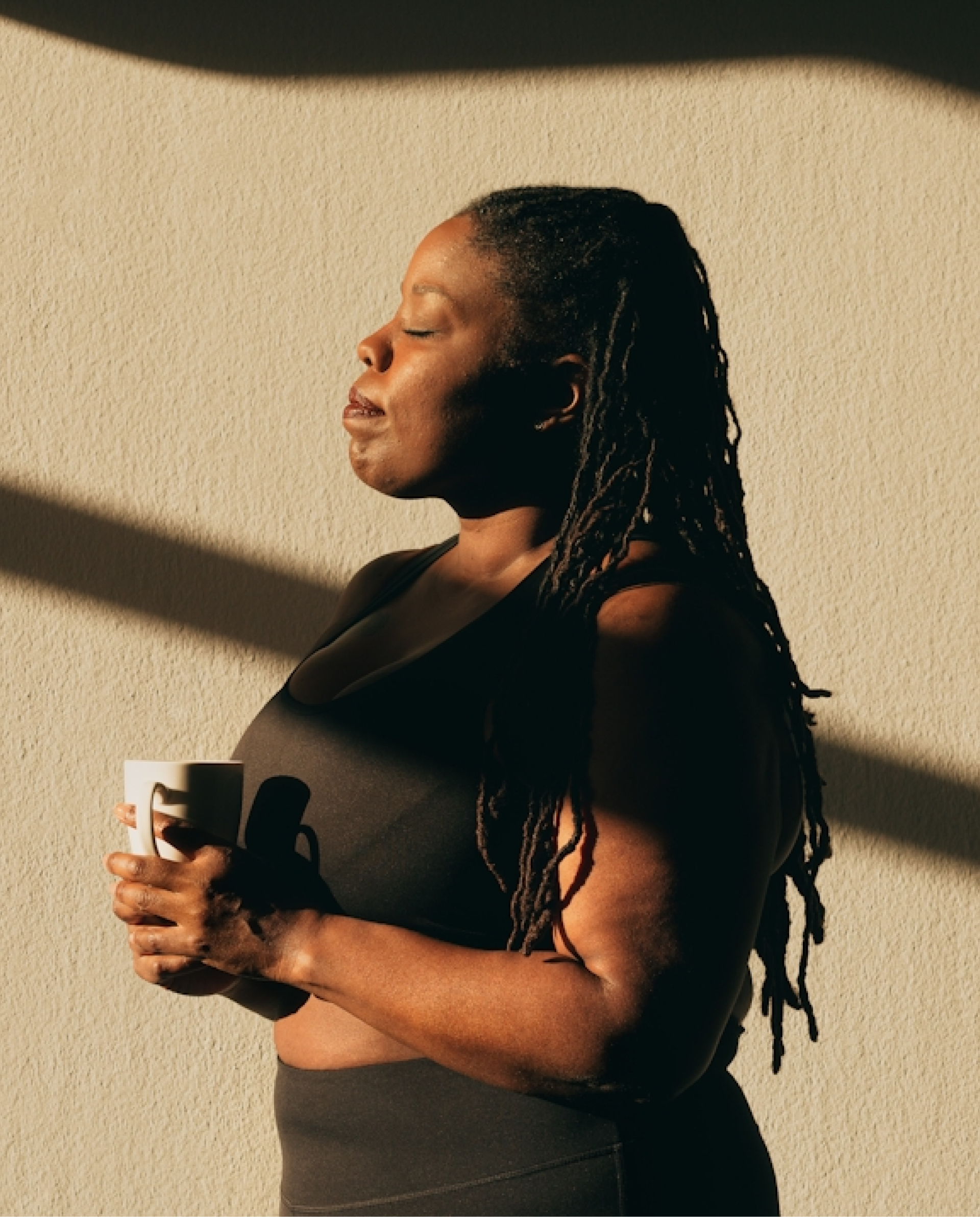 Person enjoying coffee in the sun